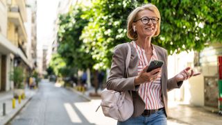 A woman talks on the phone while walking