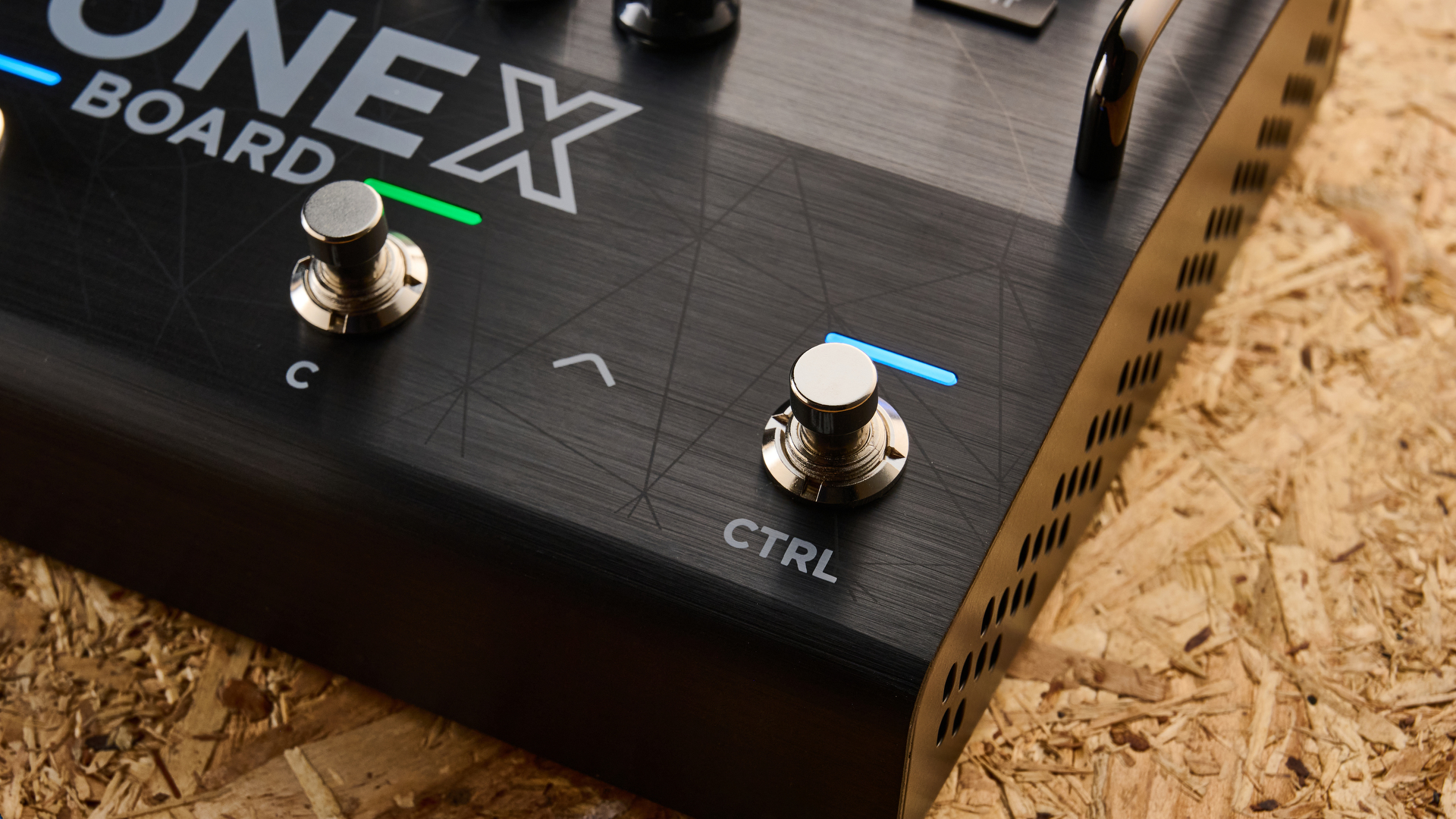IK Multimedia Tonex Board shot on OSB wood surface.