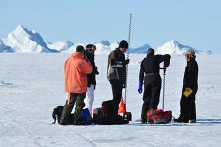 Drilling holes through the ice to measure ice thickness. By doing so we can compare results to the ice thickness obtained from the sled-mounted system.