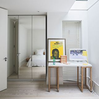 bedroom with mirrored wardrobe and table