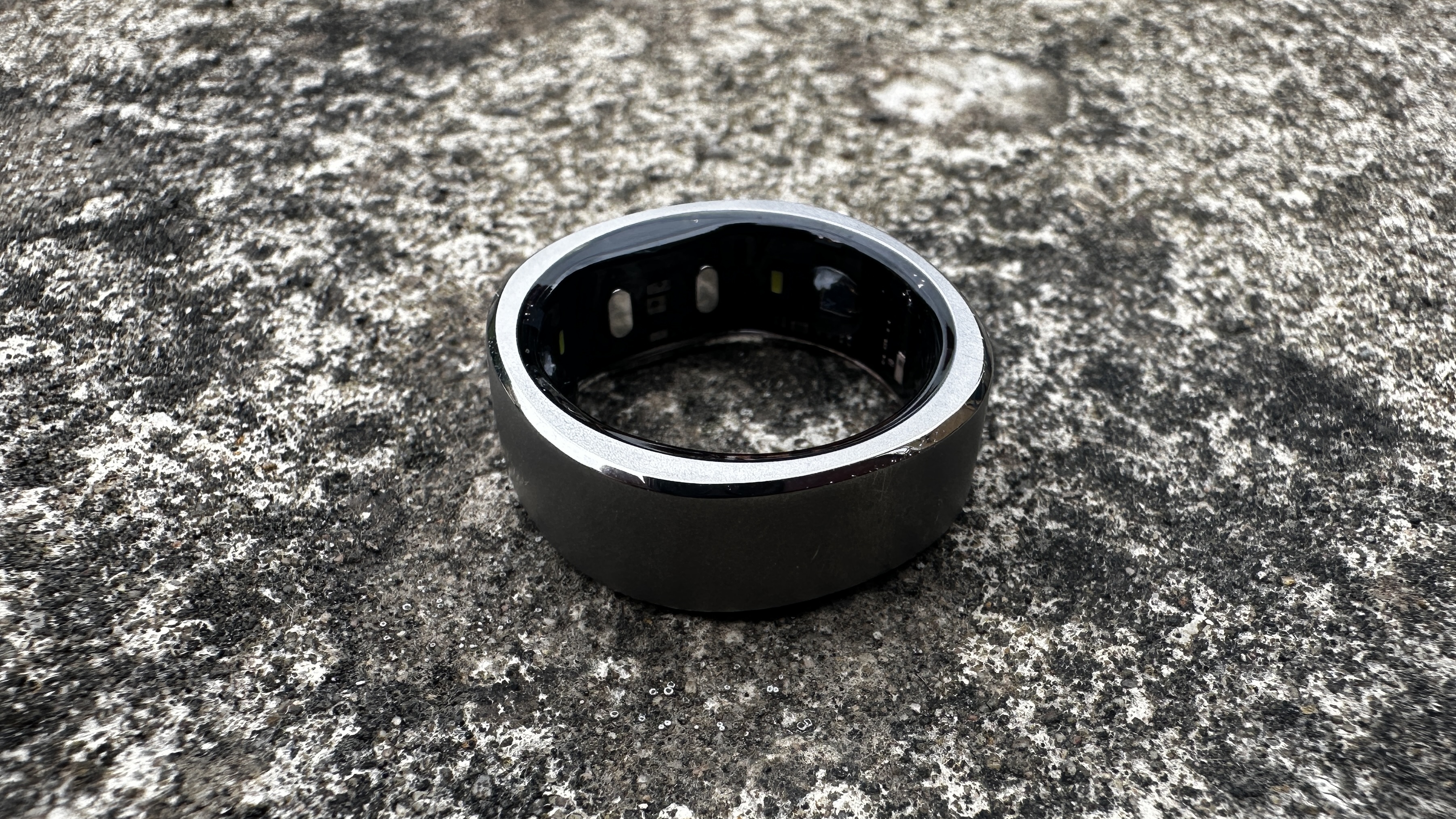 The Ringconn smart ring against a concrete surface