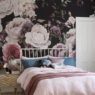 bedroom with white door and wooden floor and flower wallpaper wall