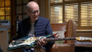 Andy Fairweather Low holds his blue Teisco Spectrum V and looks lovingly at it – the legendary guitar tech Alan Rogan got him it from the US. Eric Clapton was not best impressed by it.