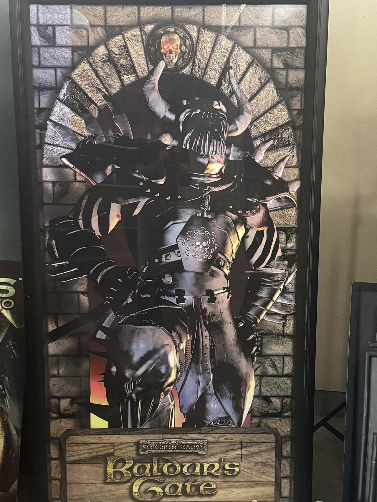 Large poster of Baldur's Gate 1 villain Sarevok in spiky armor resting foot captain morgan style on Baldur's Gate logo