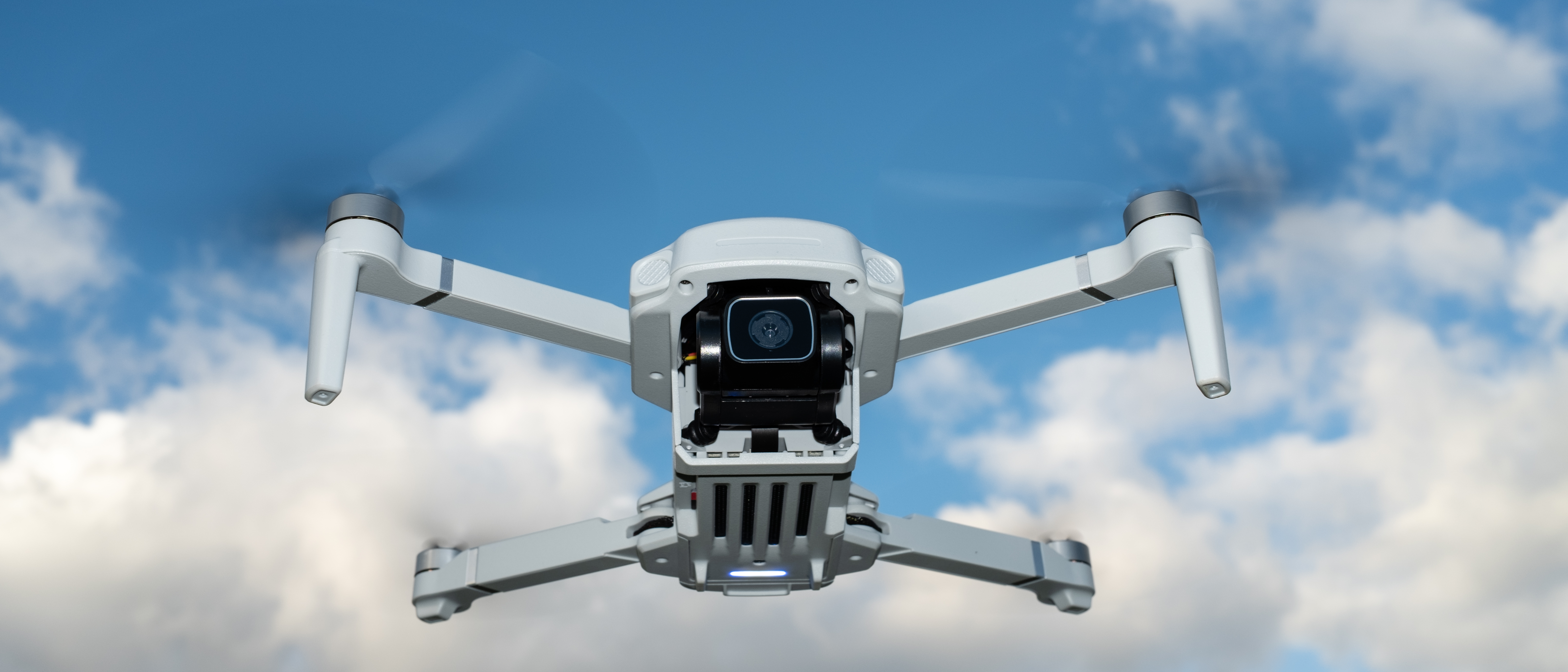 Holy Stone HS360E in flight against a blue sky