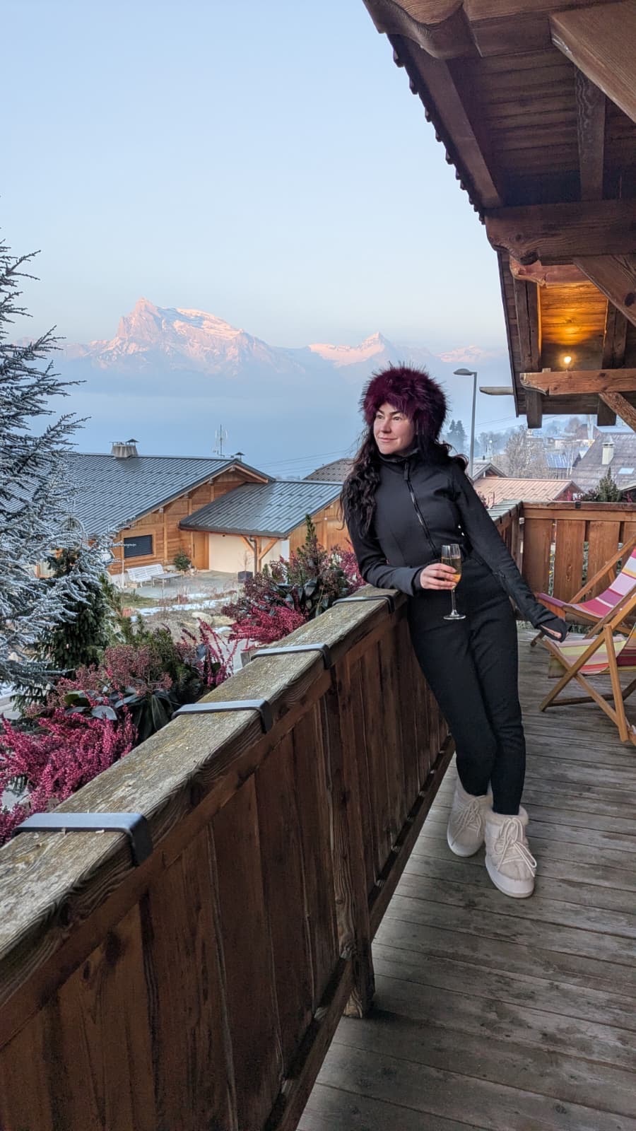 Woman overlooking French Alps from ski chalet balcony