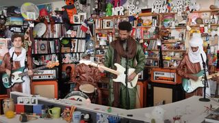 Mdou Moctar and band perform a tiny desk concert against an office backdrop