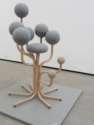 A peculiar wooden chair with spherical cushioning