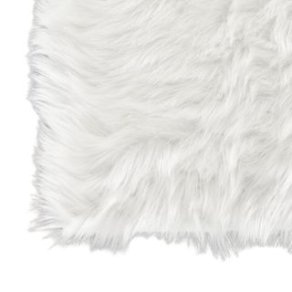 A corner of white faux fur rug