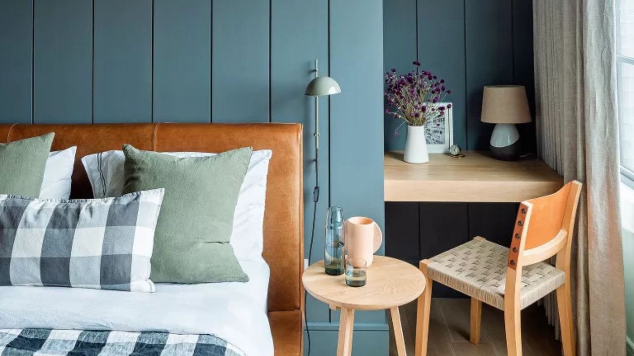 Blue bedroom with a desk in an alcove