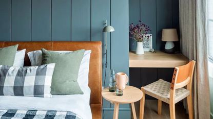 Blue bedroom with a desk in an alcove