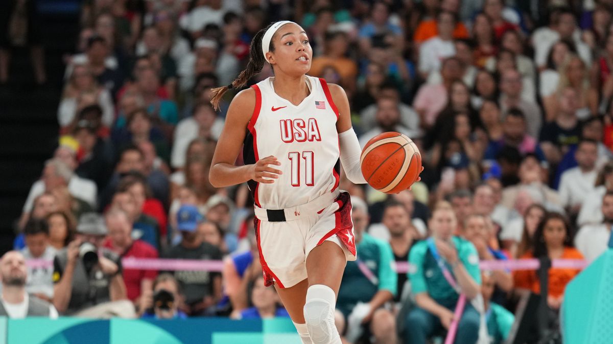 Napheesa Collier #11 of the USA Women&#039;s National Team dribbles the ball, dressed in a white vest and shorts, during the women&#039;s basketball at the 2024 Paris Olympic Games.