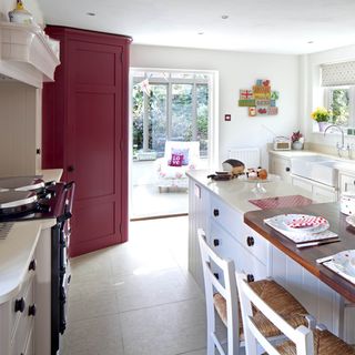 open kitchen with white flooring and garden view