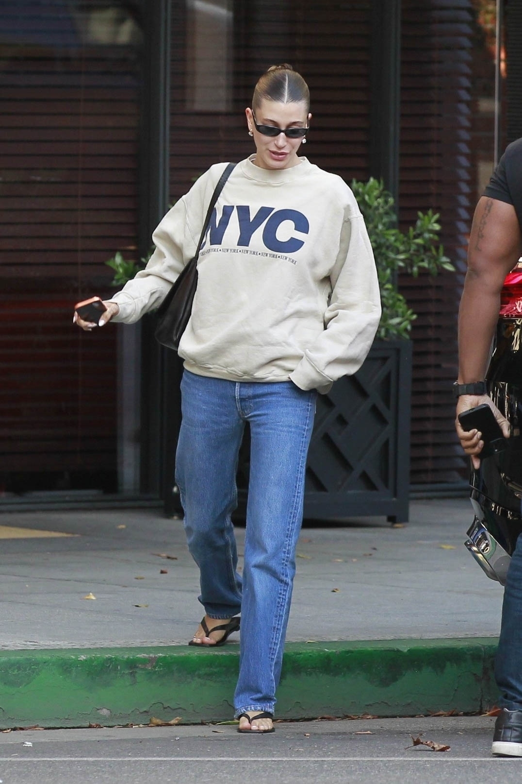 Hailey Bieber traded jeans and sneakers for the straight-leg denim trend and flip-flops