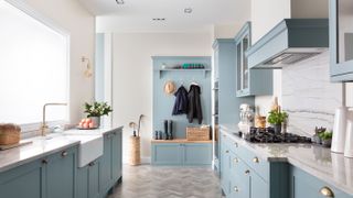 pale blue kitchen with boot room beyond