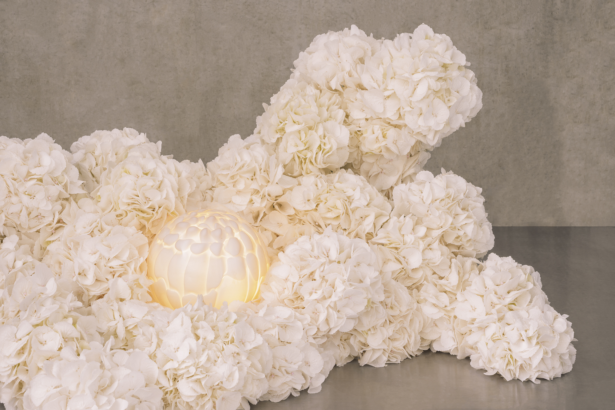 hand-formed glass lamps arranged in floral displays