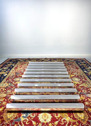 Silver pipes on red & gold rug