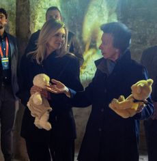 Princess Anne and First Lady Olena Zelenska wearing coats and holding teddy bears at a memorial for children in Kyiv, Ukraine