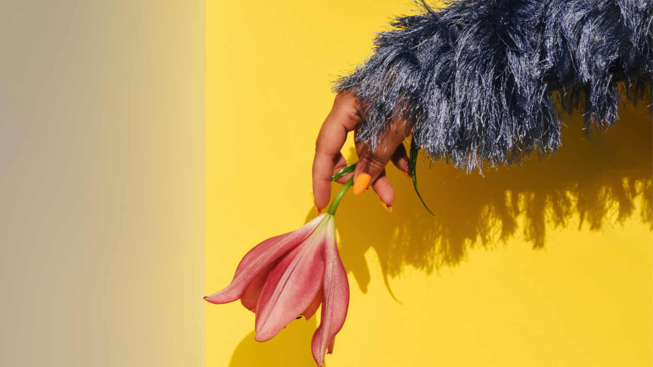 woman&#039;s hand dangling flower