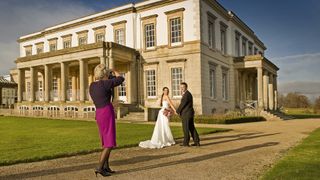 One of the best cameras for wedding photography being used to capture a couple in front of a Gerogian building in the sunshine