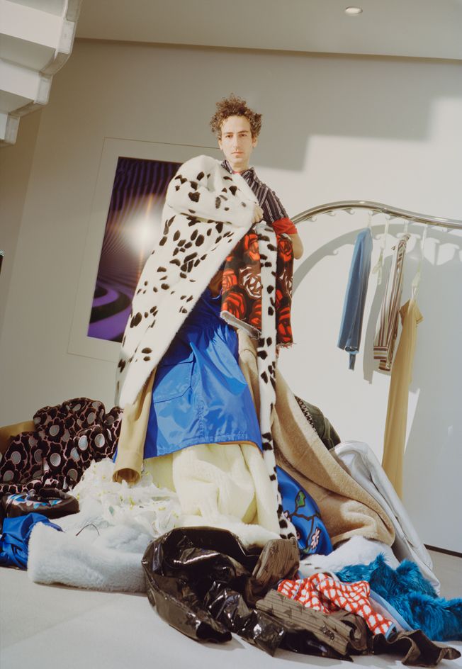 Marni creative director Francesco Risso amidst various pieces of clothing