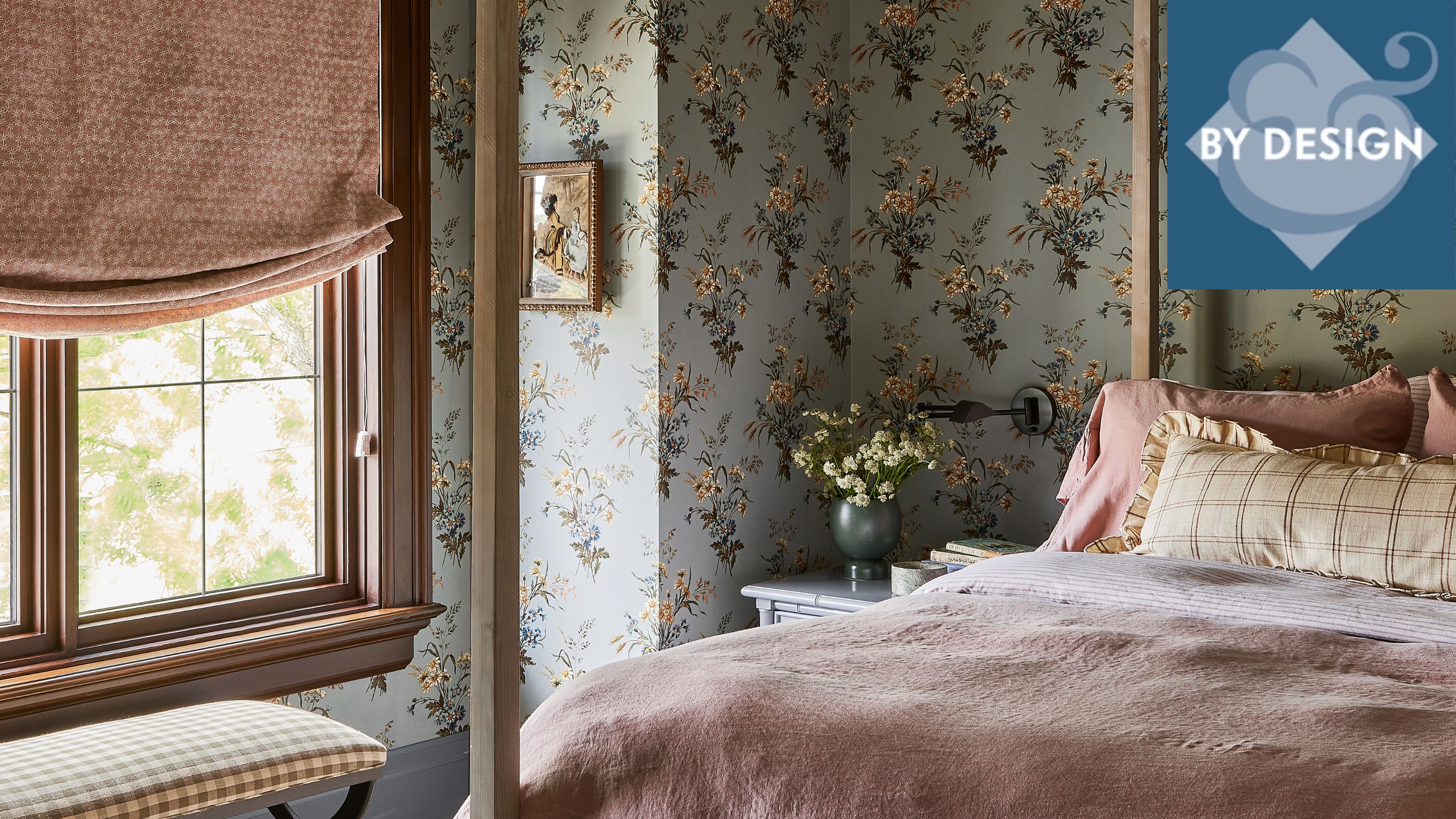 Colorful patterned bedroom with blue floral wallpaper, pink blind, pink bedding, wooden four-poster bed