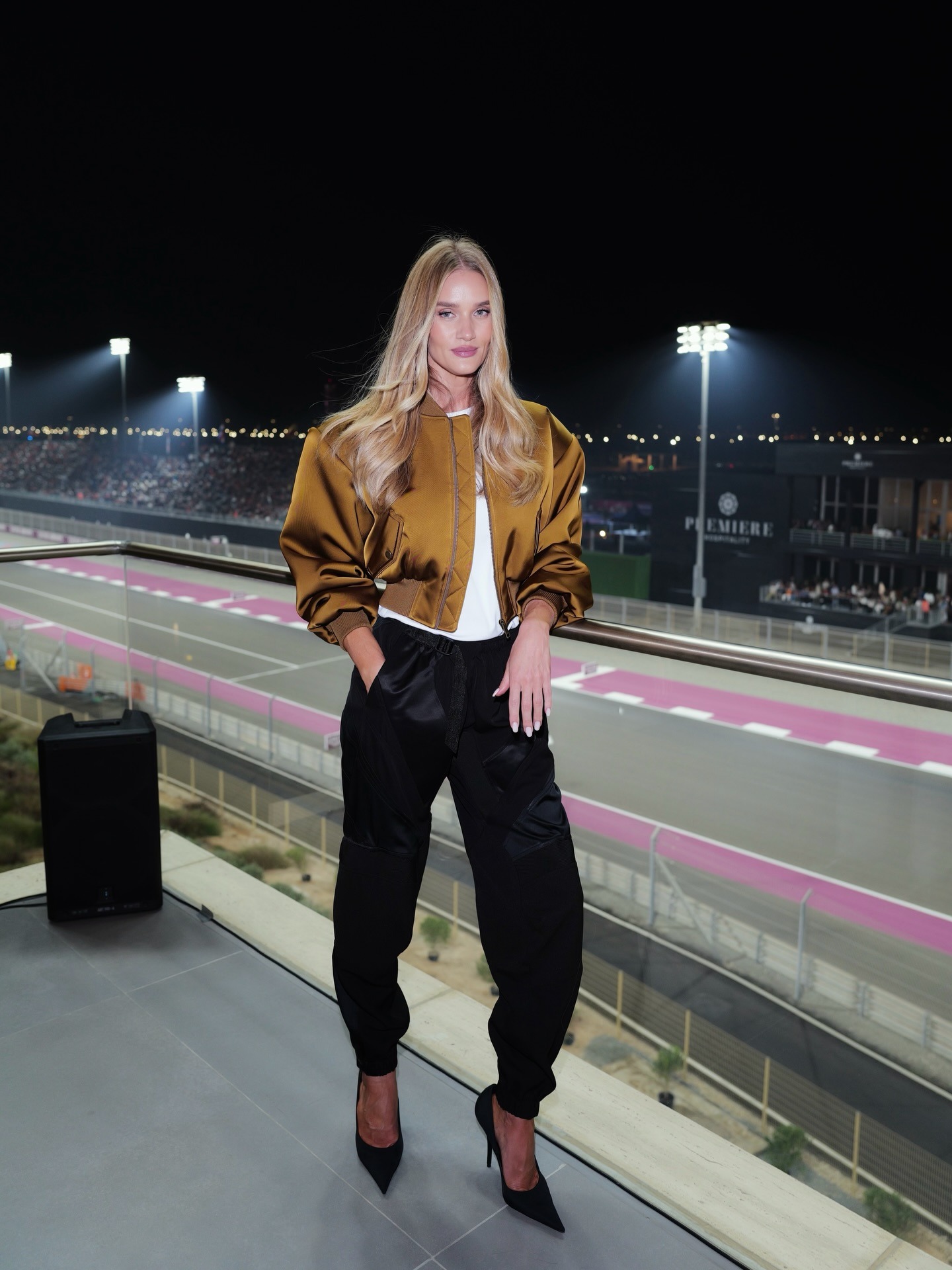 Rosie Huntington-Whiteley wearing a satin Helsa bomber jacket at the F1 Qatar Grand Prix