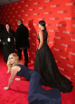 Comedienne Amy Schumer falls in front of Kim Kardashian and Kanye West at the 2015 Time 100 Gala