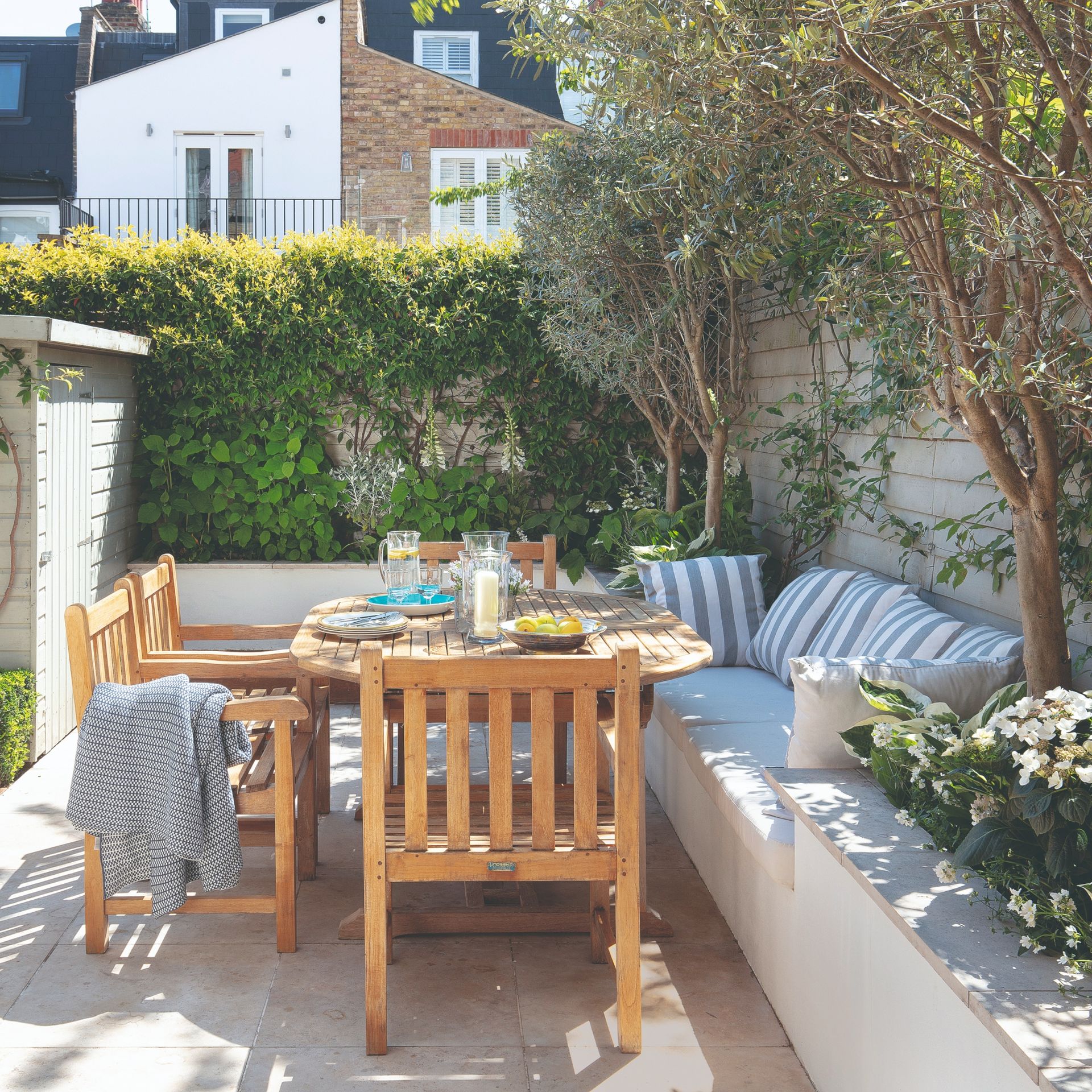 Outdoor dining space with striped cushions