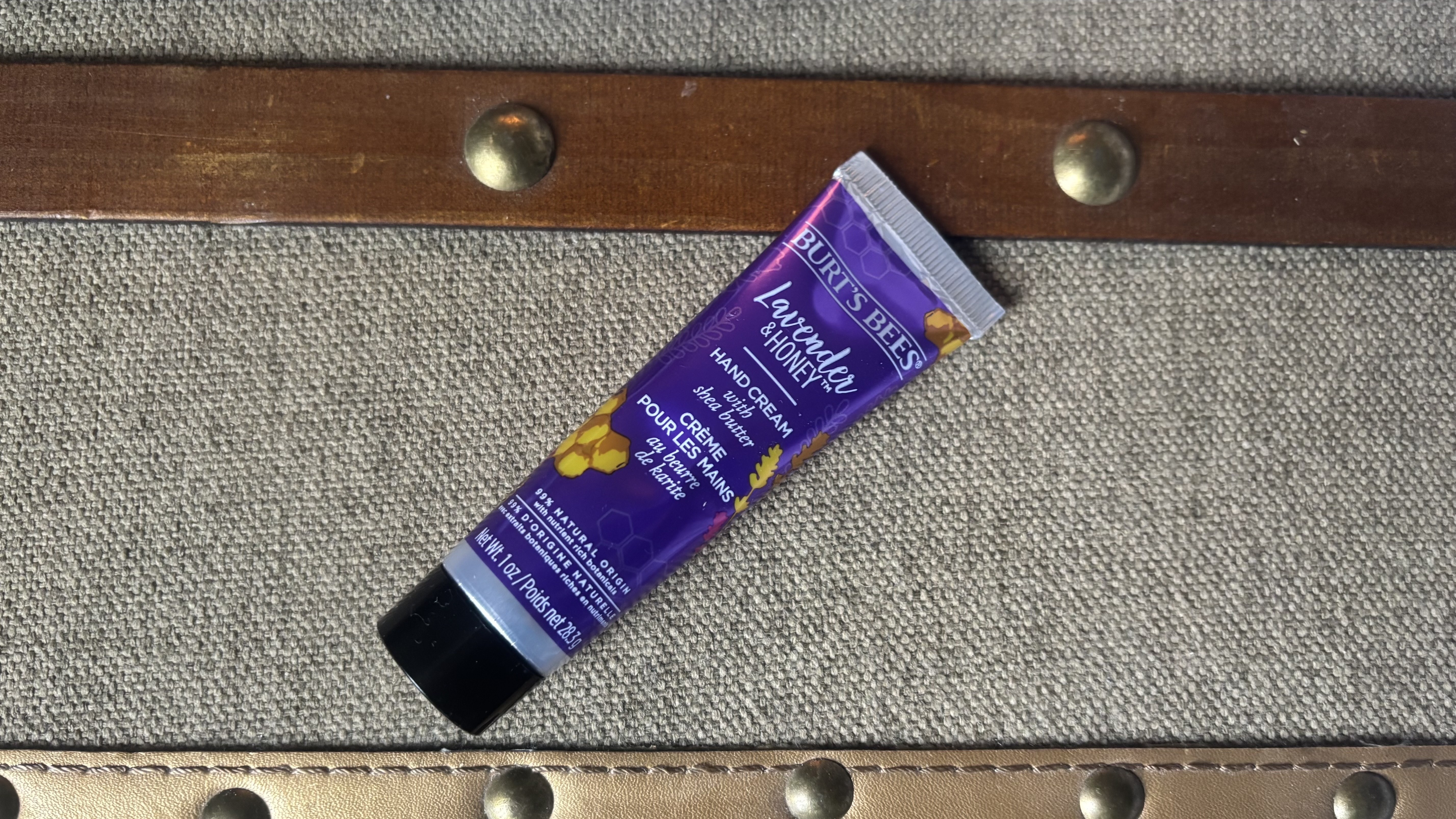 Burt's Bees Lavender&amp;amp; Honey Hand Cream on a nightstand.