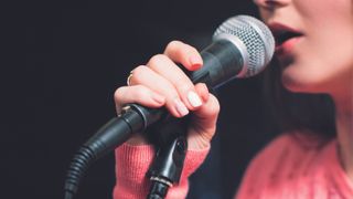 Close up of woman holding a microphone