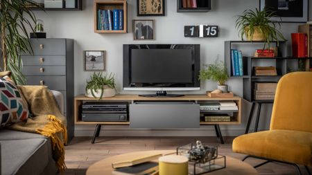 A living room with a TV wall designed like a gallery wall