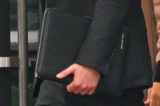 Prince Harry and Meghan Markle in New York - Harry holds an iPad case saying 'Archie's Papa'