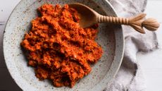 Bowl of red chilli curry paste with small spoon