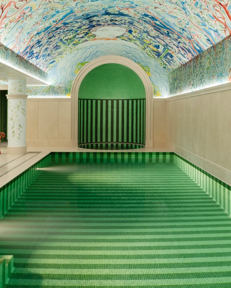 A whimsically decorated indoor pool features arched ceilings covered in murals.