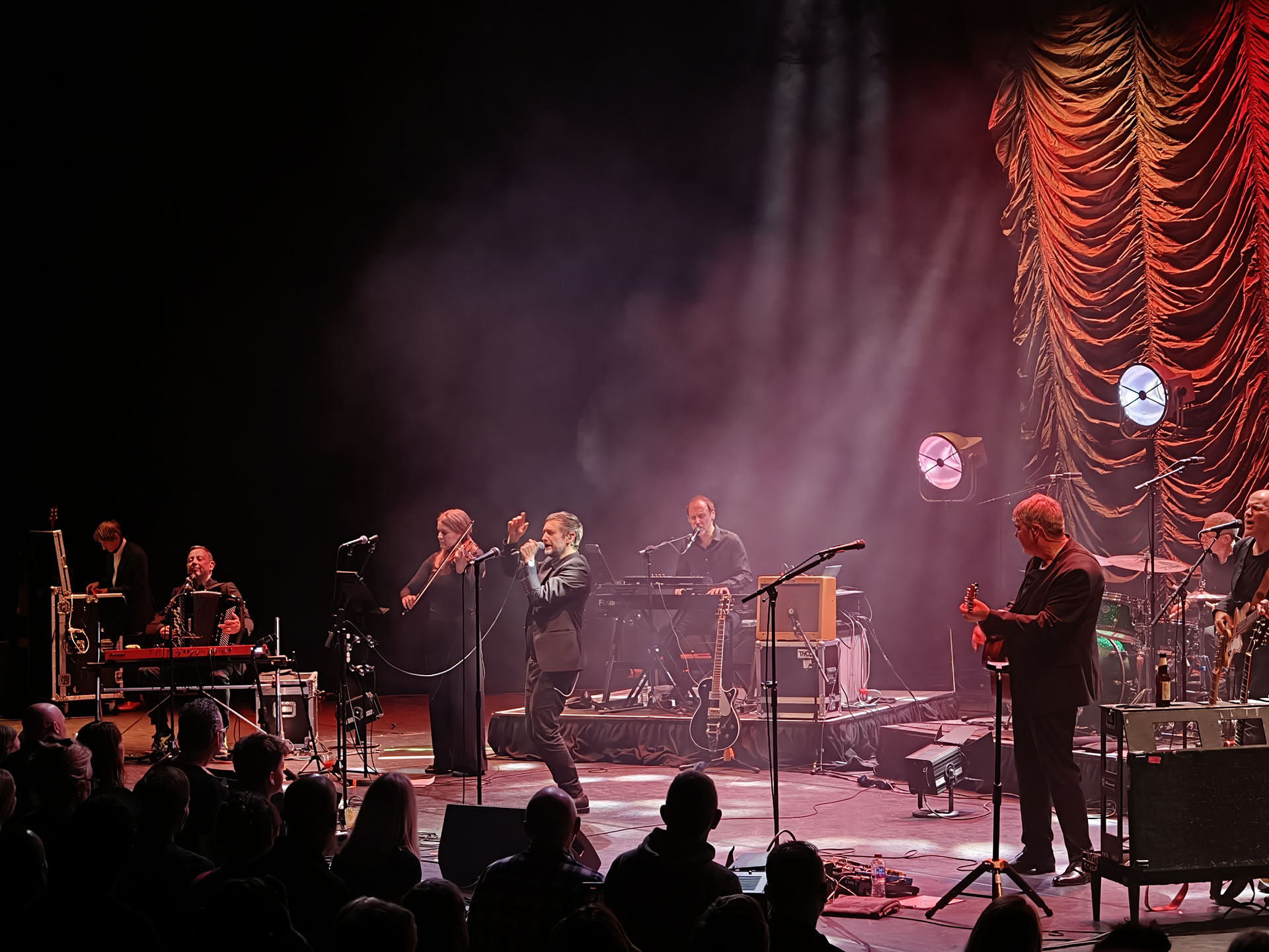 A photo of The Divine Comedy playing live.