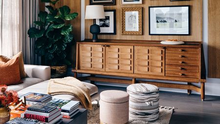 a living room with a coffee table stacked with books