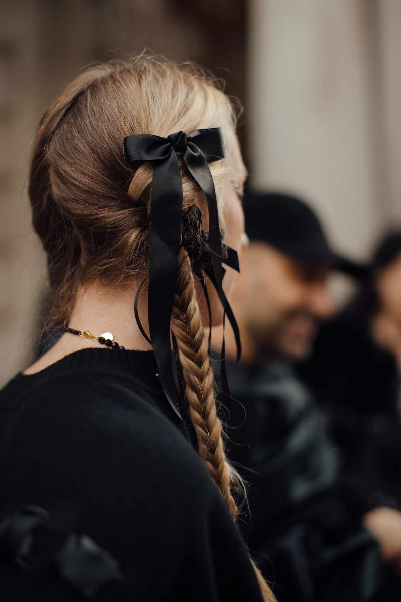 woman with pigtail braids with black satin bows