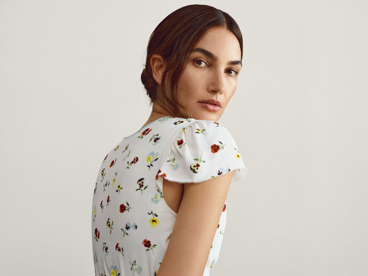 Lily Aldridge wears a white floral dress from the Gap x Dôen collaboration.