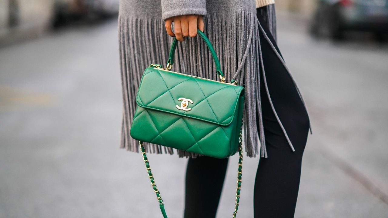 woman holding chanel handbag