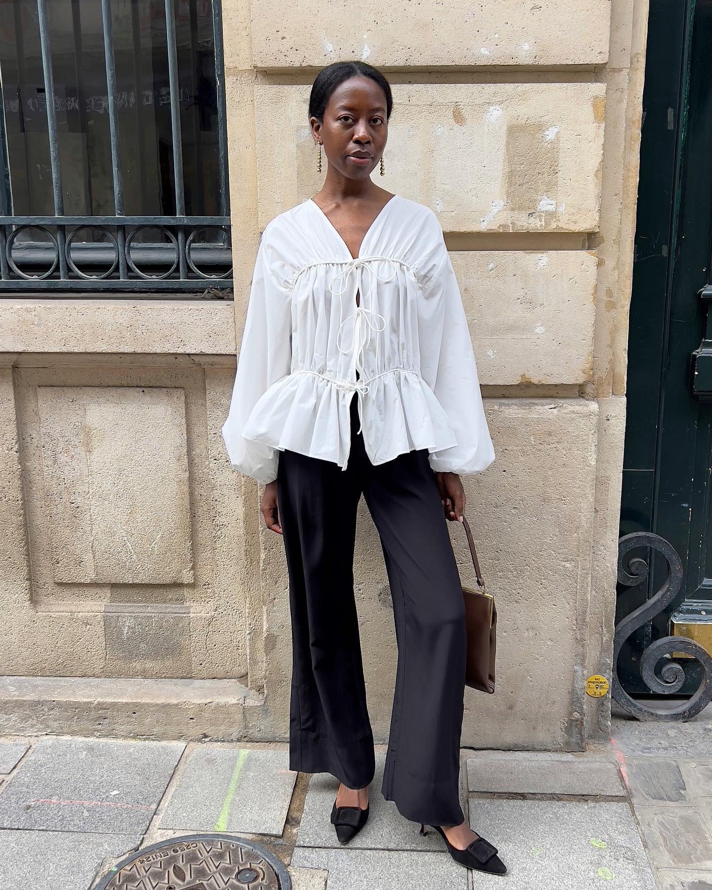 Fashion person wearing flared black jeans.