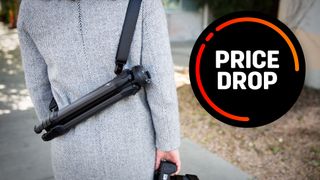 Peak Design Travel Tripod slung over a photographer's back, with the text "Price Drop"
