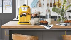 Kitchen with a yellow coffee machine on a wooden countertop