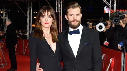 Fifty Shades Jamie Dornan & Dakota Johnson wearing black evening wear on the red carpet