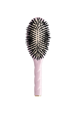Pink La Bonne Brosse hairbrush on a white background