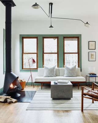 A neutral room with green painted window frame