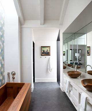 bathroom with wooden bath and basins