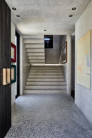 staircase with walled pictures