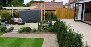 Beautiful Garden Paving with cut grass and neat bushes