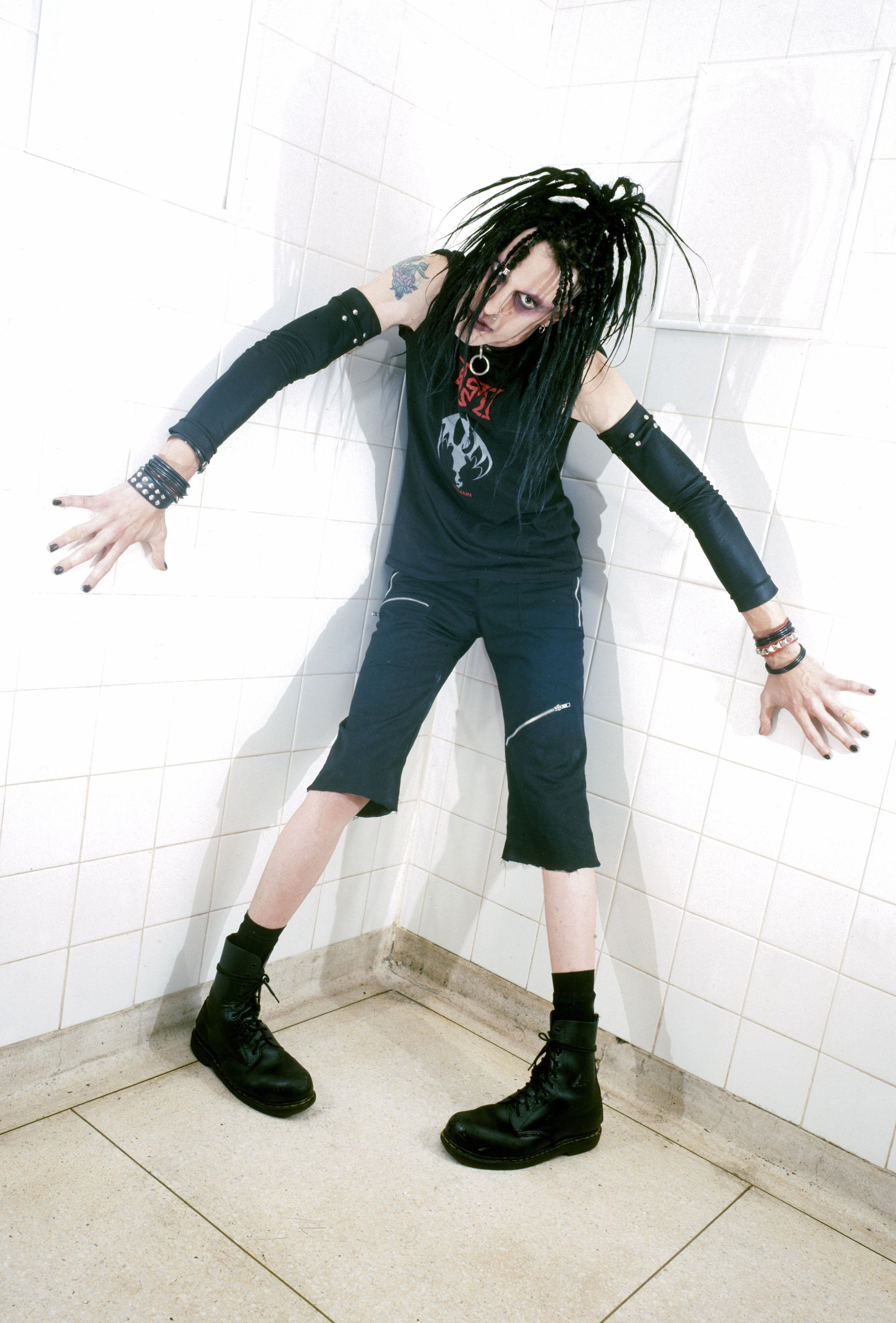 Murderdolls members posing in a public bathroom